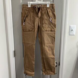 Light brown pants with adjustable bands around ankle area